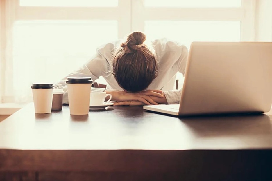 woman with head on desk woman with head on desk